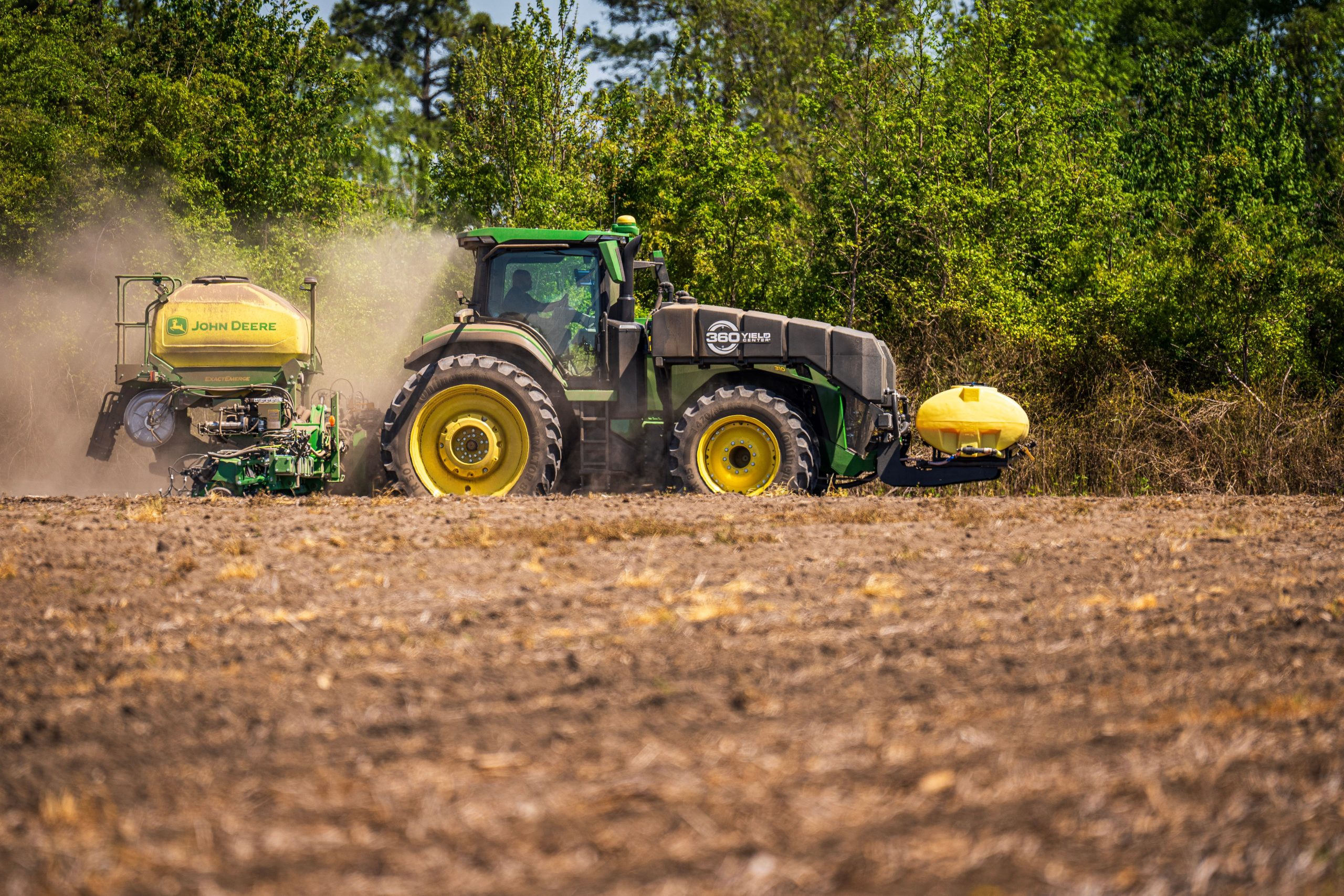 Modern tractor planting a field with precision agricultural equipment, representing Agricultural business loans, beef cattle loans, dairy cattle financing, poultry farm financing, and farm operating loans that help producers invest in equipment, livestock, daily operations, and long-term farm growth.