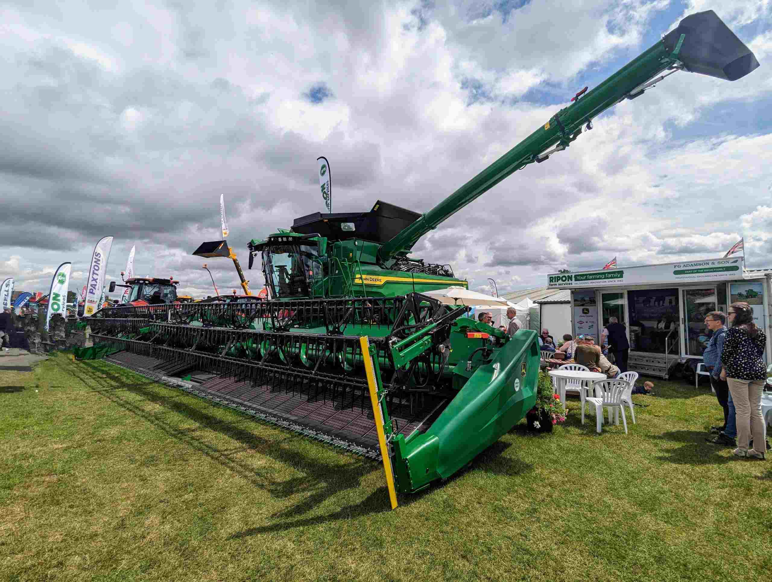 Modern combine harvester displayed on a farm equipment lot, illustrating cattle loans, dairy farm financing, agricultural well financing, planter financing, and agricultural water infrastructure financing that help farmers invest in livestock, planting equipment, reliable water systems, and efficient agricultural operations.